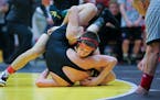 Shakopee's Ben Lunn at 113 wrestles Apple Valley's Regan Schrempp at 133 during the Minnesota State Section 2AA Team Wrestling Tournament on Friday, F