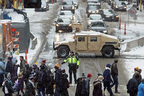 Police watched as pedestrians crossed 6th Street South at Nicollet while a humvee blocked off traffic Saturday.
