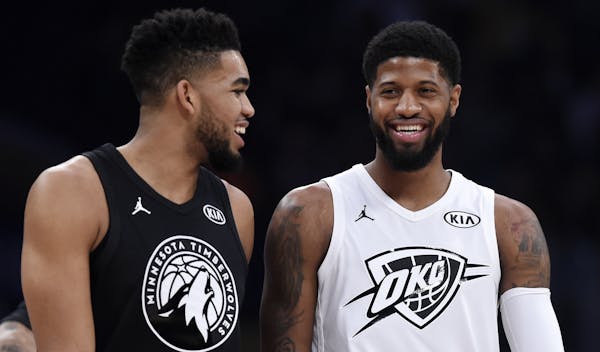 Team Stephen’s Karl-Anthony Towns and Team LeBron’s Paul George chatted during a stop in play Sunday night. Towns had 17 points and 10 rebounds.