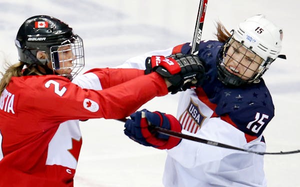 Meghan Agosta (2) and Anne Schleper (15) pushed off of each other in the second period of the gold medal game in Sochi. Team Canada beat Team USA in o