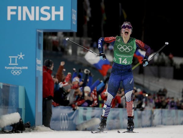 Jessie Diggins celebrates after winning the gold medal in the during women's team sprint freestyle cross-country skiing final at the 2018 Winter Olymp
