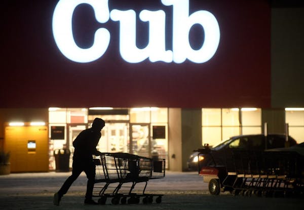 An employee pushed together shopping carts at Cub in Blaine. High-end grocery stores are absent in Anoka County.