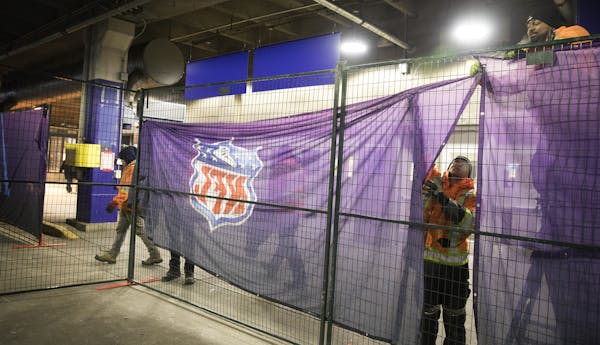 Workers from Modu-Loc USA built a barrier to direct rail passengers without Super Bowl tickets on Sunday to the bus area at the outdated Mall of Ameri