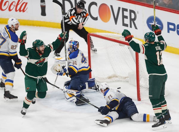 Jason Zucker (16) and Eric Staal (12) celebrate the Wild's fourth goal Tuesday at Xcel Energy Center.