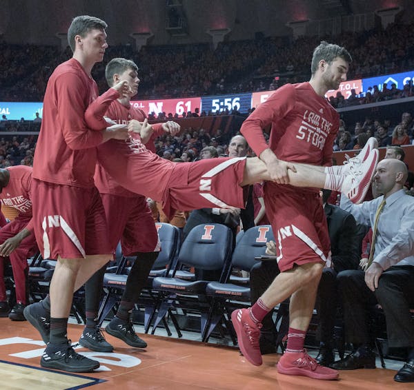 Players on the Nebraska bench carried off a teammate in a skit after a bucket in Champaign, Ill., earlier this month. (AP photo by Rick Danzl)