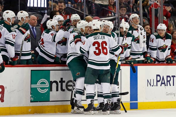 Minnesota Wild right wing Chris Stewart (10) is congratulated by teammates after scoring a goal against the New Jersey Devils during the second period