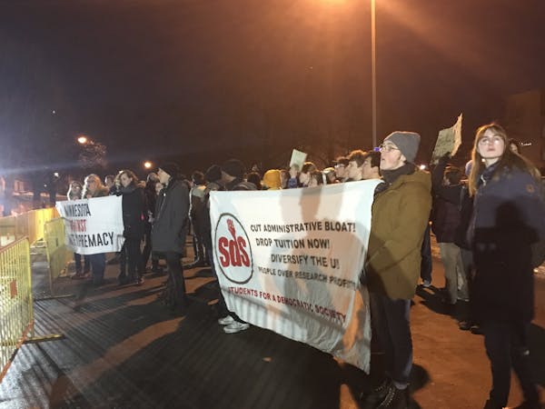 Dozens of protesters shouted and held signs outside the University of Minnesota building where conservative commentator Ben Shapiro is speaking Monday