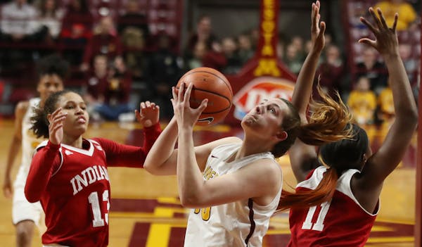 Gophers center Jessie Edwards rebounded over Indiana forward Kym Royster (11) and Jaelynn Penn (13) in the first half at Williams Arena
