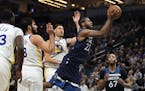 Andrew Wiggins glided between Golden State guard Klay Thompson, right, and forward Omri Casspi in the first half of Sunday’s Wolves victory and stay