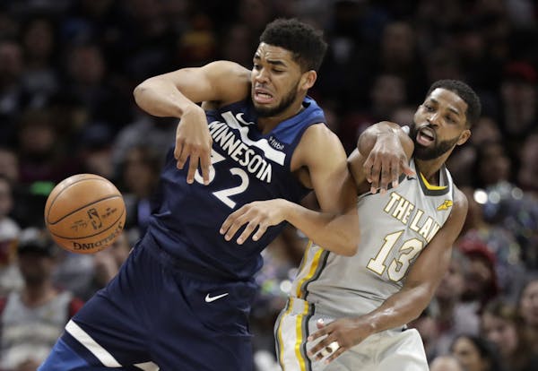 Karl-Anthony Towns battled the Cavaliers’ Tristan Thompson for a rebound earlier this month in Cleveland. (AP photo by Tony Dejak)