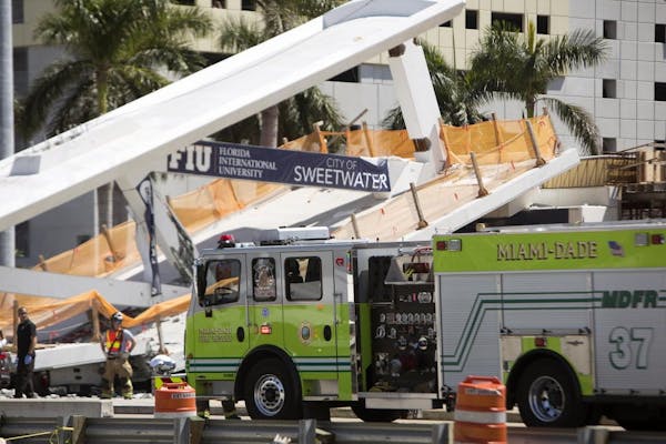 Responders on the scene of the FIU pedestrian bridge collapse Thursday, March 15, 2018 at SW 109th Avenue and 8th Street in Miami, trapping unknown nu