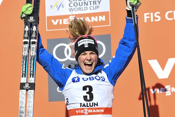 Afton’s Jessica Diggins celebrated on the podium after finishing in second place in the 10-kilometer freestyle pursuit in the final race of the Worl