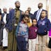 Dar Al Farooq Islamic Center Executive Director Mohamed Omar, center, spoke about the charges filed against three people in the bombing of the mosque 