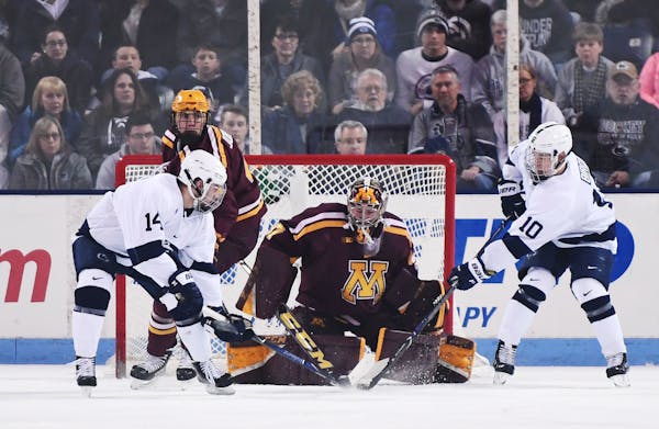 Gophers goaltender Eric Schierhorn stops a shot by Penn State’s Brandon Biro (10) as Penn State’s Nate Sucese waits for a rebound.