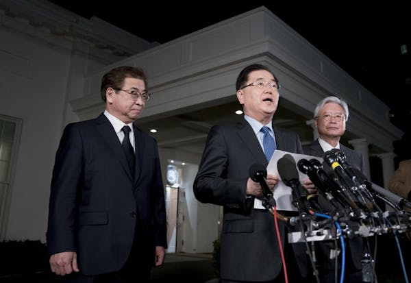 South Korean national security director Chung Eui-yong, center, spoke outside the White House on Thursday night. With him were intelligence chief Suh 