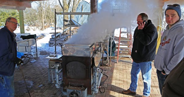 Jim Smith, left, Dave Swager and Vince Anderson, right, boiled maple sap as as their animal spring syrup-making ritual began in earnest last week.