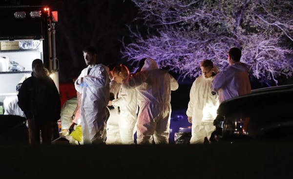 Crime scene investigators gather near the area where a suspect in a series of bombing attacks in Austin blew himself up as authorities closed in, Wedn