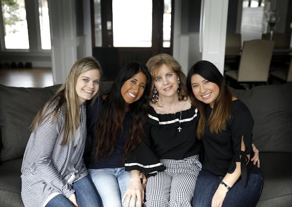 Julie Ledy, second from right, founder of the nonprofit Adoption Is Love, with her daughters (from left): Jenna Huiras, Chloe Ledy and Jillian Ledy.