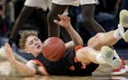 Calvin Wishart (10) of Delano fell to the floor after being fouled in the first half.