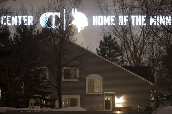 The lights from the signage on the side of the new Vikings practice facility in Eagan illuminate the homes on Lockwood Drive in Mendota Heights.