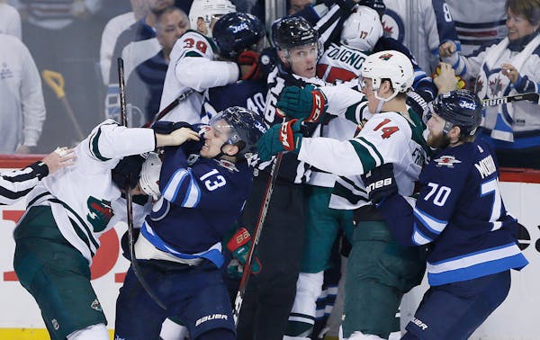 Left: The Wild went down swinging Friday in its Game 2 beatdown in Winnipeg.