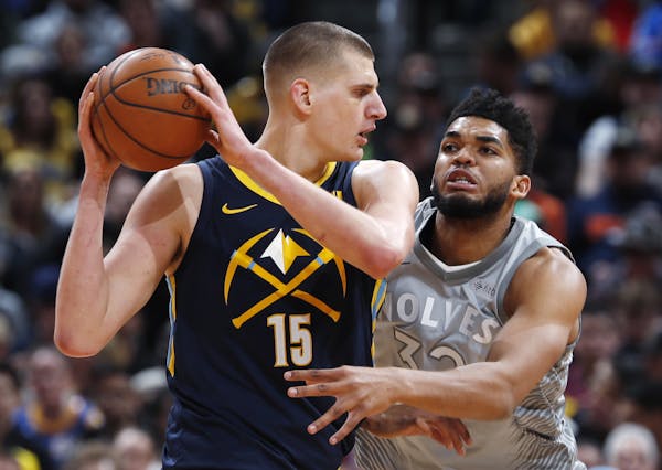 Karl-Anthony Towns defended the Nuggets’ Nikola Jokic during the first half in Denver on Thursday.