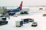 File photo: A Sun Country flight at the gate at Terminal 2 during a winter storm.