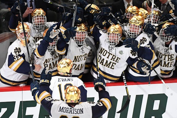 Teammates celebrated with Notre Dame forward Jake Evans after Evans' game-winning goal in the final seconds of the third period.