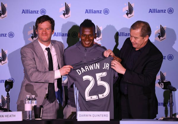 Darwin Quintero stood Amos Magee, left, MNUFC director of player personnel and coach Adrian Heath at the news conference where he was introduced Monda