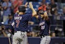 Minnesota Twins' Eddie Rosario (20) celebrated with Joe Mauer (7) after Rosario hit a grand slam off Tampa Bay pitcher Sergio Romo during the eighth i