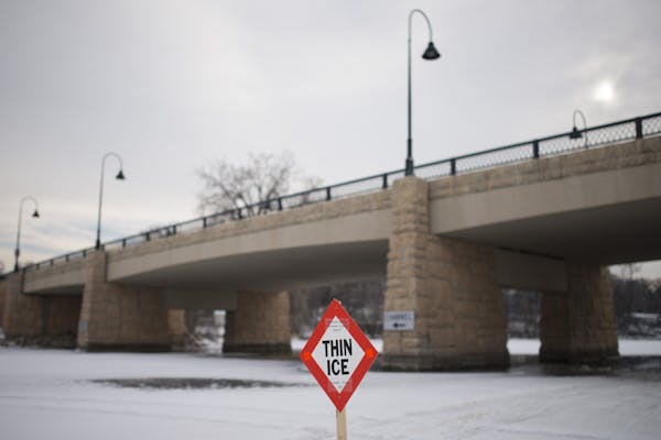 A thin ice sign marks the area under the bridge separating Gray’s Bay and Wayzata Bay. ] (Aaron Lavinsky | StarTribune) Over the course of a particu