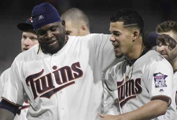 Minnesota Twins starting pitcher Jose Berrios, right, and third baseman Miguel Sano celebrate the team's 2-1 win over the Cleveland Indians in 16 inni