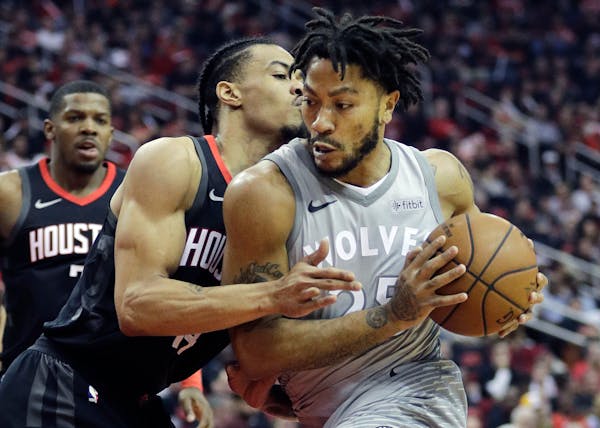 Minnesota Timberwolves' Derrick Rose drives around Houston Rockets' Gerald Green during the first half in Game 1 Sunday in Houston.