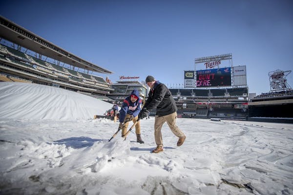Target Field grounds crew worked to remove ice and snow from the field and concourse in preparation for tomorrow's home opener at Target Field, Wednes