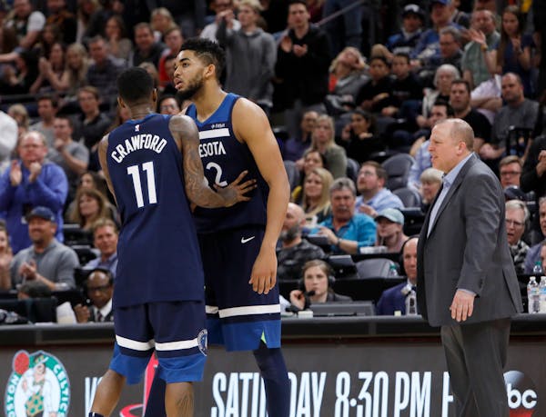 Karl-Anthony Towns, right, had to be held back by Wolves teammate Jamal Crawford after he was called for his second technical foul and ejected against