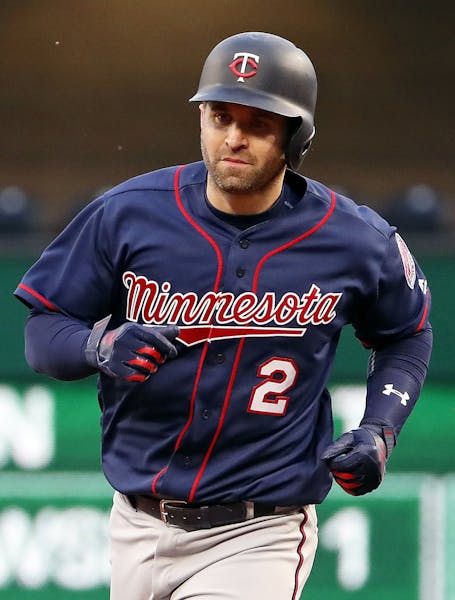 Minnesota Twins' Brian Dozier rounds second after hitting a solo home run off Pittsburgh Pirates starting pitcher Ivan Nova in the third inning of a b