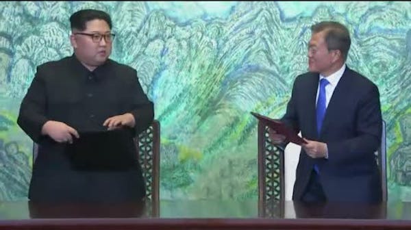 Raw: Kim and Moon embrace after talks