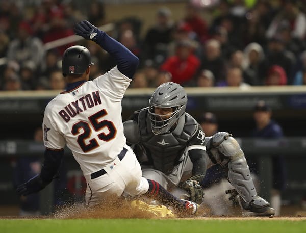 Minnesota Twins center fielder Byron Buxton (25) was safe at home when Chicago White Sox catcher Omar Narvaez (38) couldn't handle the throw from Chic