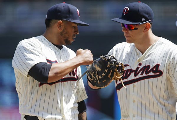 Minnesota Twins pitcher Fernando Romero, left, making his major league debut, is congratulated by first baseman Logan Morrison before being lifted in 