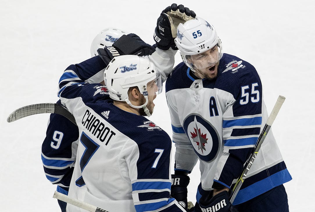 Winnipeg Jets' Mark Scheifele skates by Minnesota Wild fans after scoring  an empty-net goal in the third period of Game 4 of an NHL hockey  first-round playoff series Tuesday, April 17, 2018