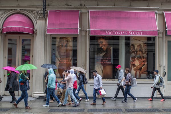 Shoppers walk past the Victoria's Secret store on Broadway in the Soho neighborhood of New York.