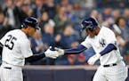 On-deck batter Gleyber Torres, left, congratulated teammate Miguel Andujar after Andujar hit a solo home run during the second inning against the Twin