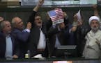 Iranian lawmakers burn paper U.S. flag