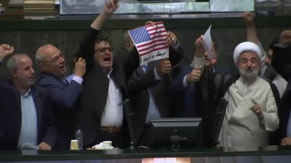 Iranian lawmakers burn paper U.S. flag