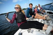 Cara Hanson, daughter of Pehrson Lodge Resort owner Eric Hanson, waved to a passing fishing boat while out on an afternoon sailing trip on Lake Vermil