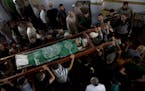 Palestinians carry the body of Mousab Abu Leila, 29, during his funeral after he was killed during a protest on the border with Israel, in Gaza City, 