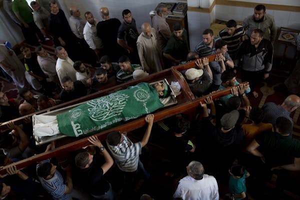Palestinians carry the body of Mousab Abu Leila, 29, during his funeral after he was killed during a protest on the border with Israel, in Gaza City, 