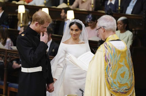 The royal couple smile with joy at the altar