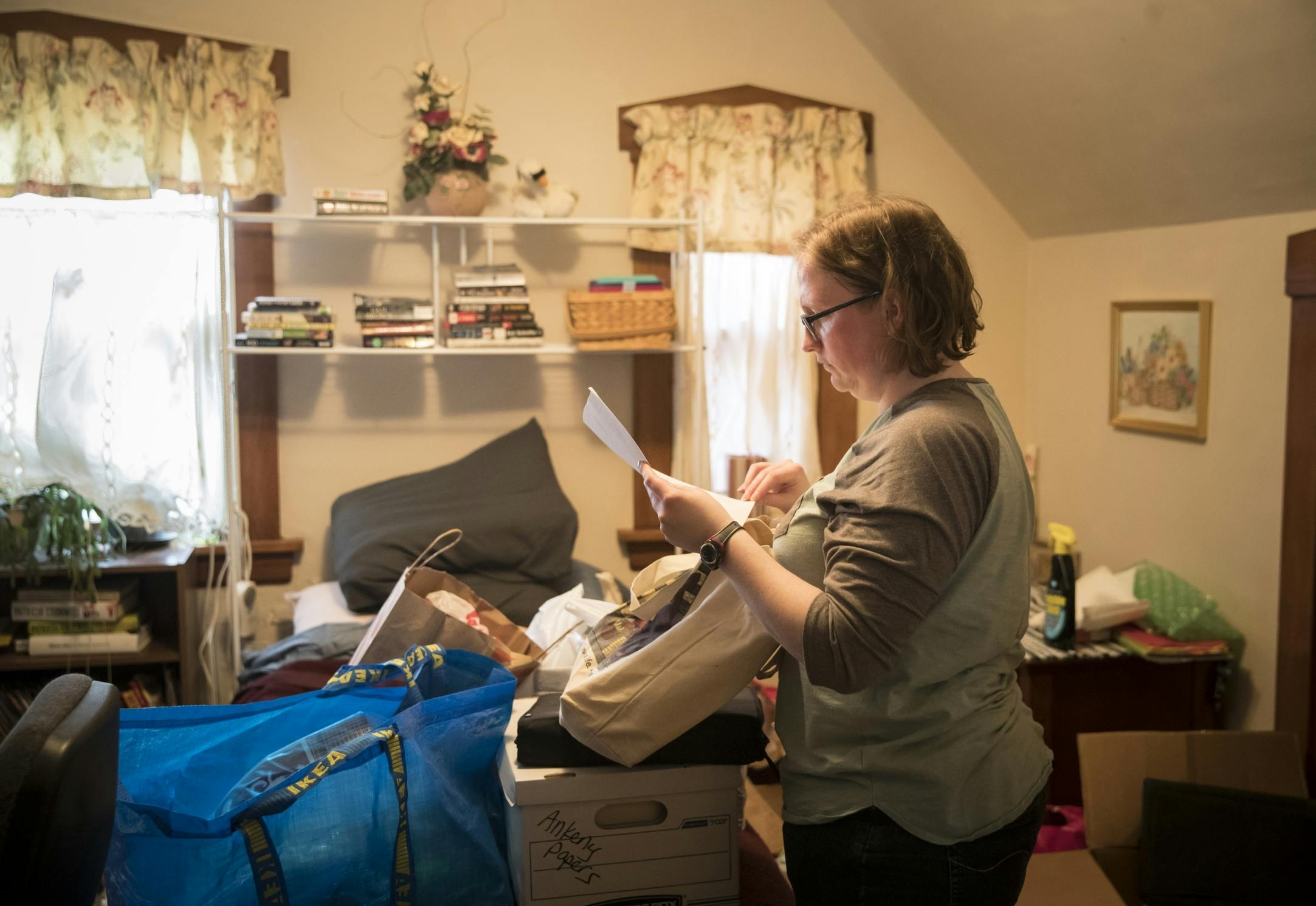 Angela Byrne packed up her mother's belongings at her home in Robbinsdale. Byrne lived with and cared for her mom during her cancer treatments; she died in February. Byrne said her bosses were supportive, but workplace pressures were ever-present.