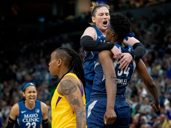 Lindsay Whalen (13) and Sylvia Fowles (34) celebrated after Fowles scored and was fouled on the play in the fourth quarter.